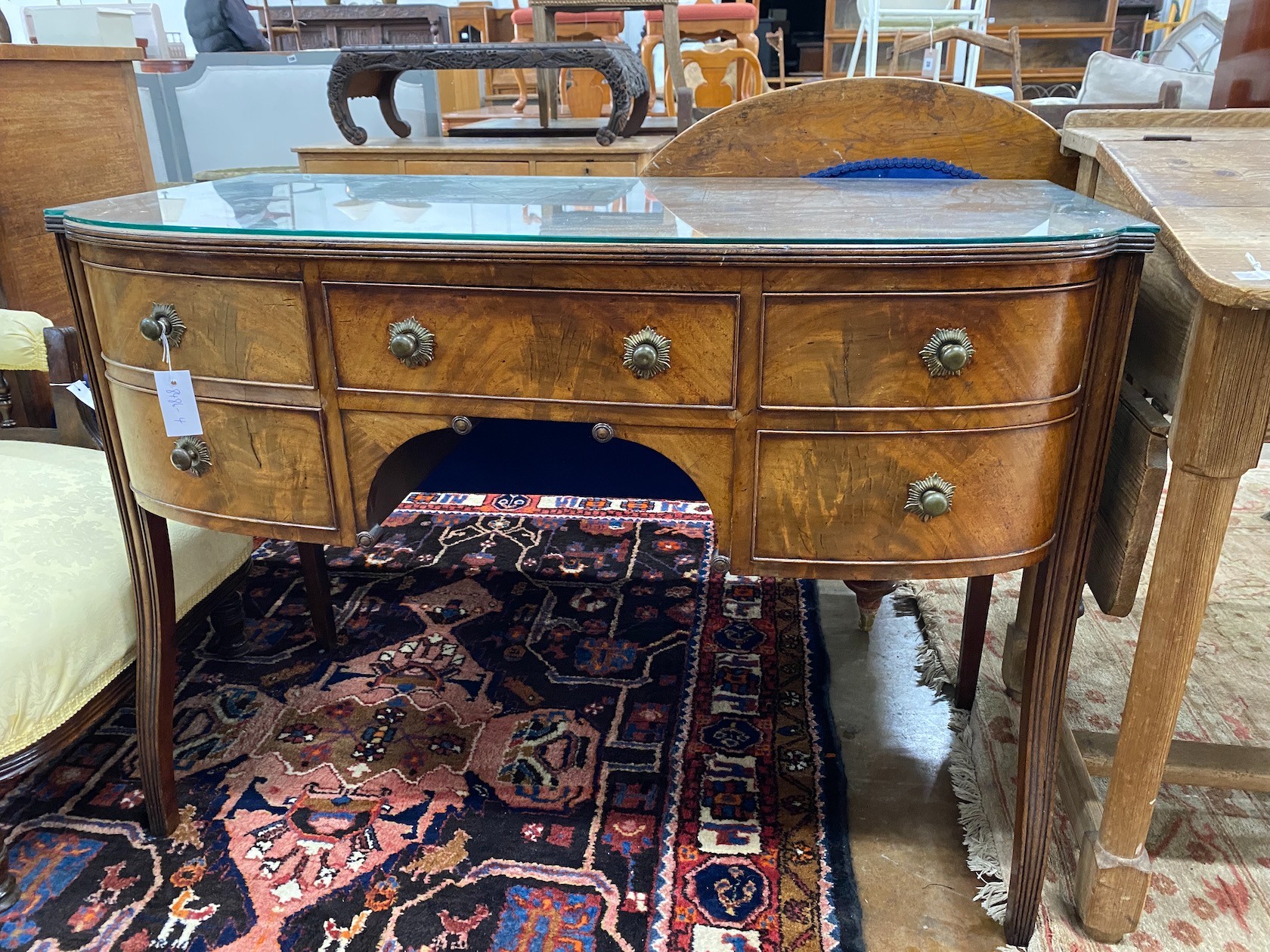 A George III Sheraton period mahogany bow front dressing table, length 112cm, depth 56cm, height 80cm